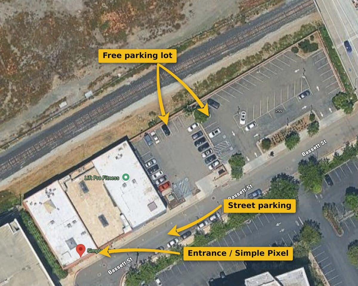 Aerial map: Simple Pixel is in the brick building on Bassett St; the free parking lot sits behind the building, and street parking runs along Bassett St.